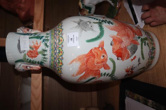 A Chinese famille verte vase, with twin elephant handles and decorated with shubunkins, restored height 22cm
